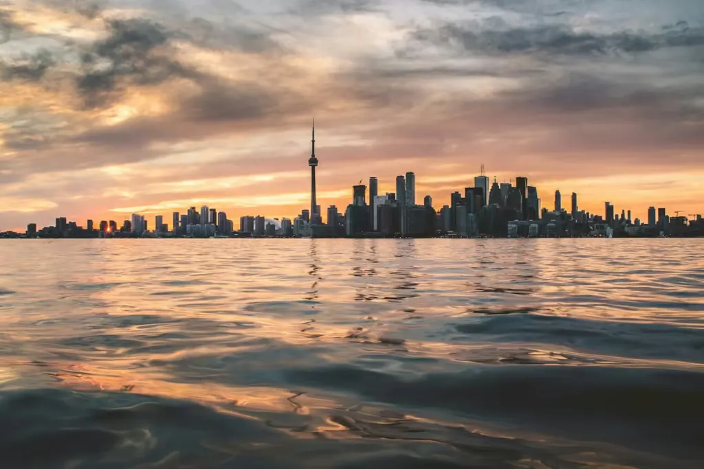 Toronto skyline and CN Tower seen from the water near the Toronto Islands at sunset